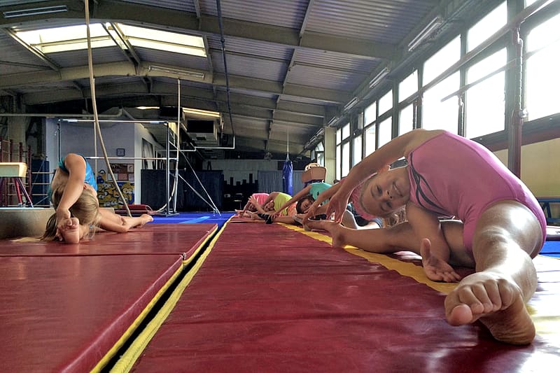 Deca vežbaju na strunjači na treningu gimnastike